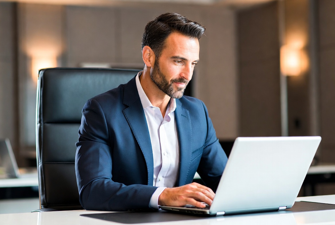 a man seating in from of computer